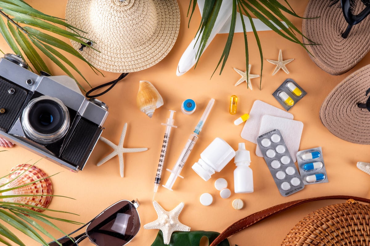 Travel medicine study materials with first aid kit, passport, and medical supplies